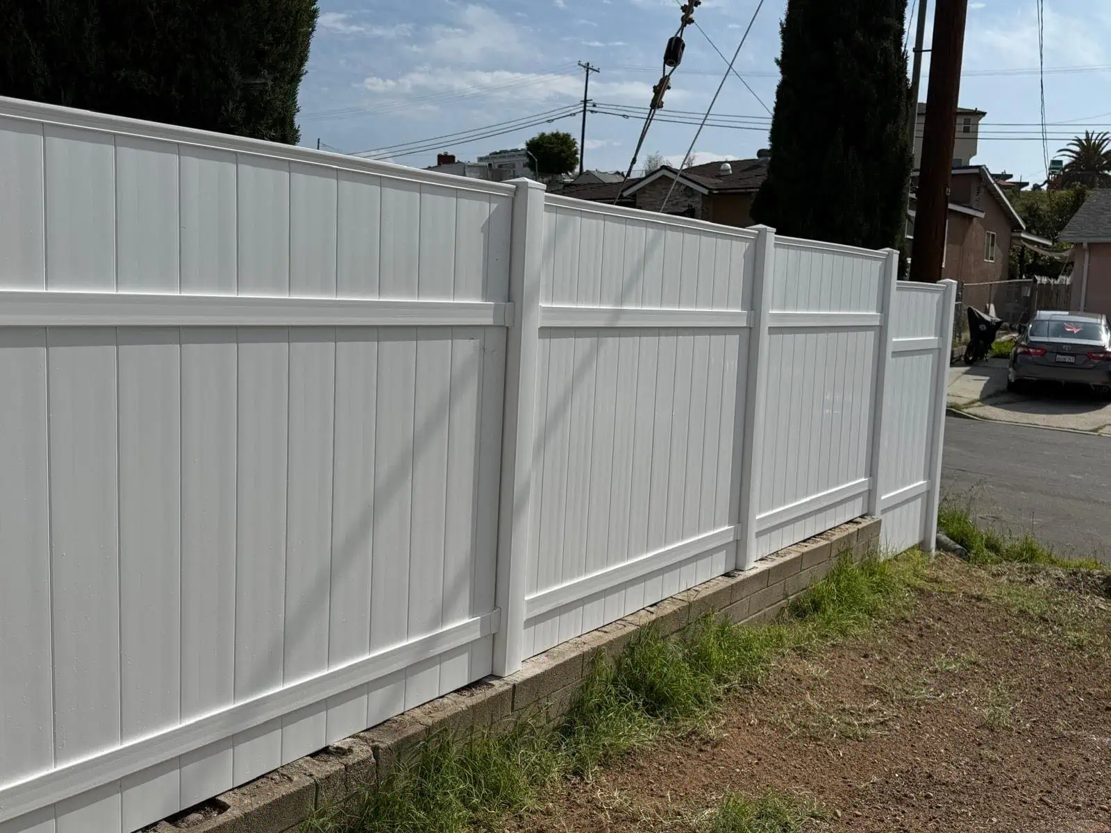 High-quality white vinyl fencing for backyard privacy and security.